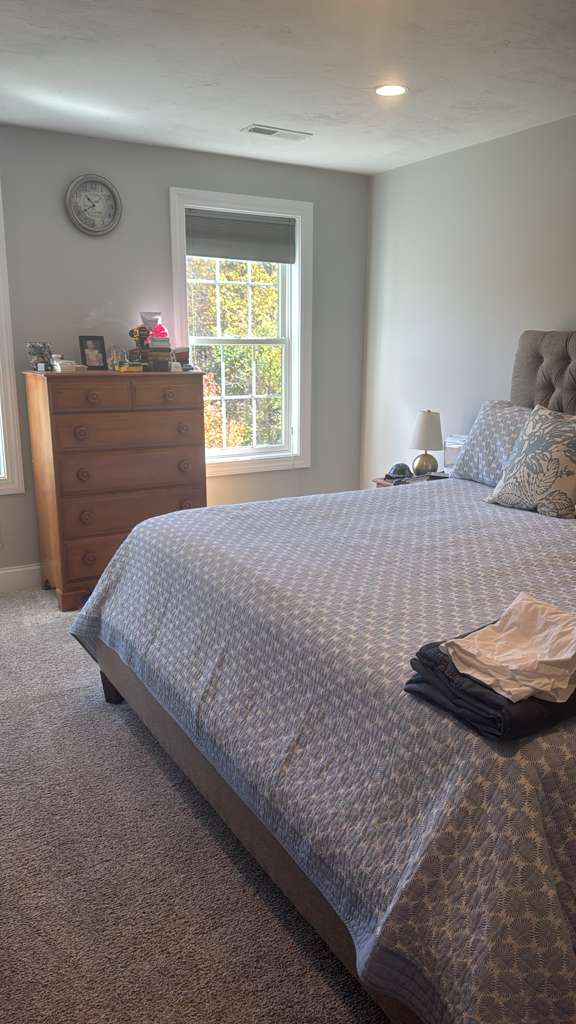 Neatly made bed in a clean bedroom